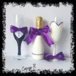 Botella de cava decorada con lazo morado y pedrería