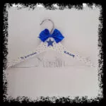 Percha infantil blanca con lazo y estrella azul